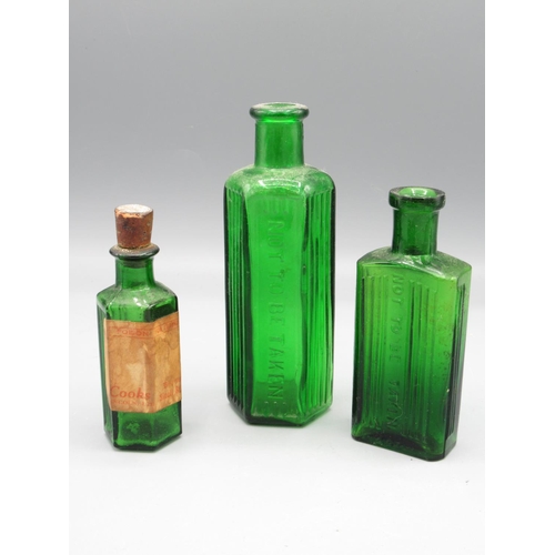 232 - Seven small green glass poison bottles incl. one with original Cooks of Lincoln shop sticker (7)