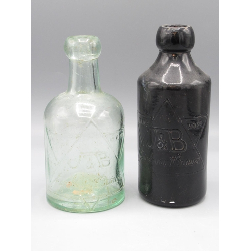 235 - Jewsbury and Brown clear glass soda water bottle and a brown glass ginger beer bottle, both with emb... 