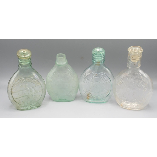 249 - Four clear glass feeding bottles incl. and Son Leeds, 'The Cottage Feeding Bottle' with thermometer,... 