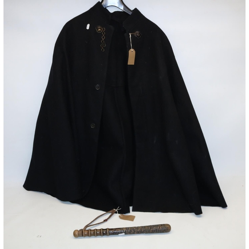 1288 - Mid 20th century woollen police cape with lion head fasteners, and a wooden truncheon with leather t... 