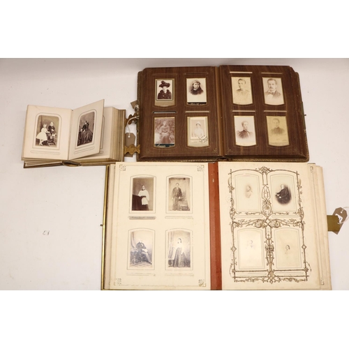 411 - Three Victorian photograph albums containing period carte de visite portraits and cabinet cards