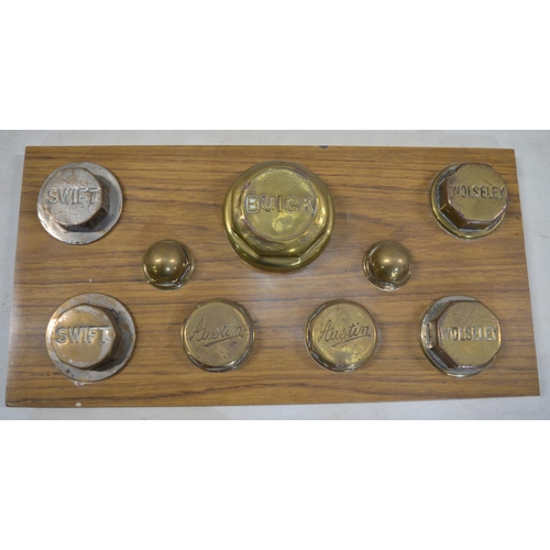 276 - Collection of plaque mounted vintage car wheel nuts from Swift, Austin, Buick and Wolesley. Plaque d... 