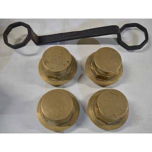 277 - Four large brass carriage wheel nuts (diameter 13cm) and a large carriage spanner (does not fit bolt... 