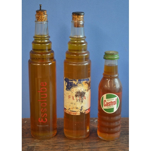 290 - Three vintage moulded glass oil bottles with contents to include 1 quart examples from Esso and a sm... 