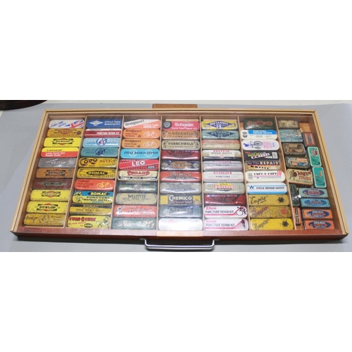 325 - Large cased collection of bicycle repair tins (some with contents) including, rubberweld, Empire, Ro...