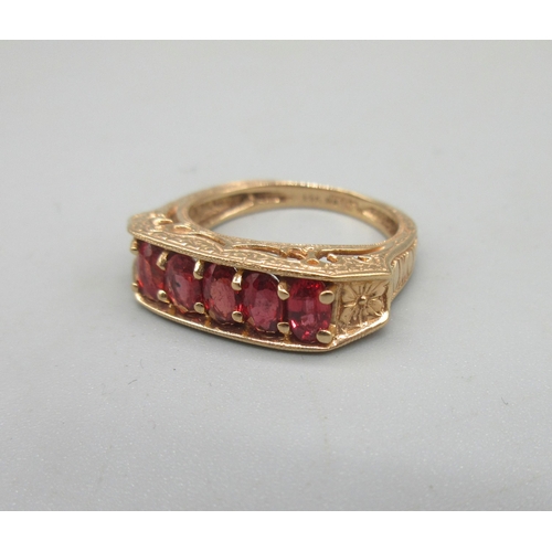 10 - 14ct rose gold ring set with five oval cut red sapphires in ornate mount, size N, stamped 14k, 4.9g