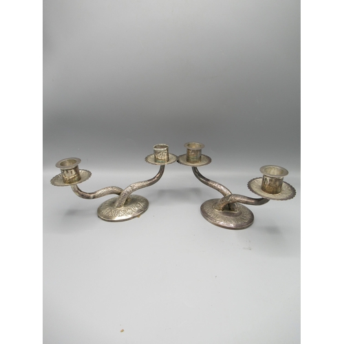 194 - Pair of Kelantan silver two-branch candlesticks, on circular bases (2)