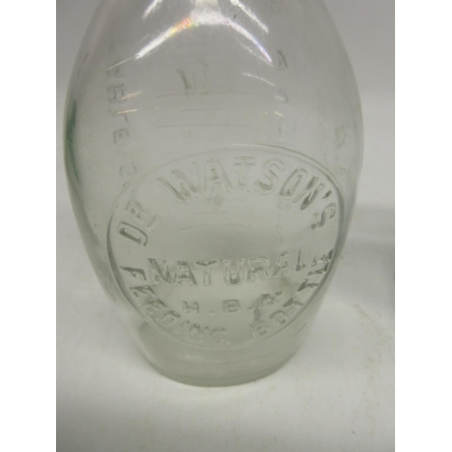 241A - Three clear glass antique feeding bottles, one with thermometer, and a C. Wass Chemist clear glass b... 