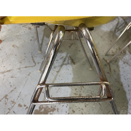 619 - Six vintage Eames for Herman Miller yellow fibreglass and chrome plated DSS stacking chairs, moulded... 