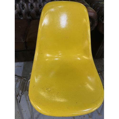 621 - Four vintage Eames for Herman Miller yellow fibreglass and chrome plated DSS stacking chairs, moulde... 