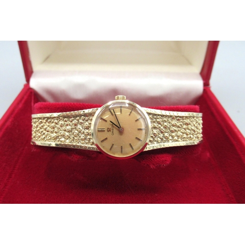 1025 - Ladies Omega 9ct gold wristwatch, signed gold tone dial, applied baton indices, integrated mesh brac... 