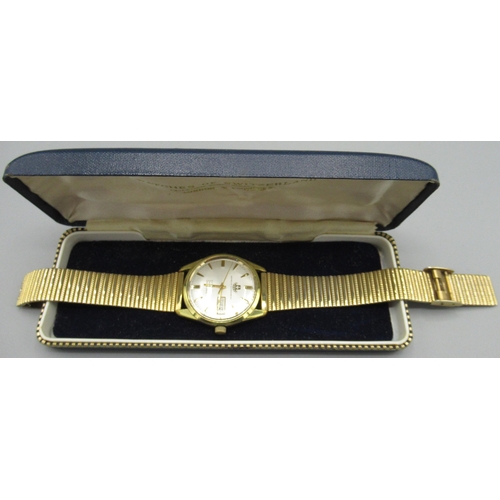 1030 - Watches of Switzerland Seafarer gold plated wristwatch with day date, signed silvered sunburst dial,... 