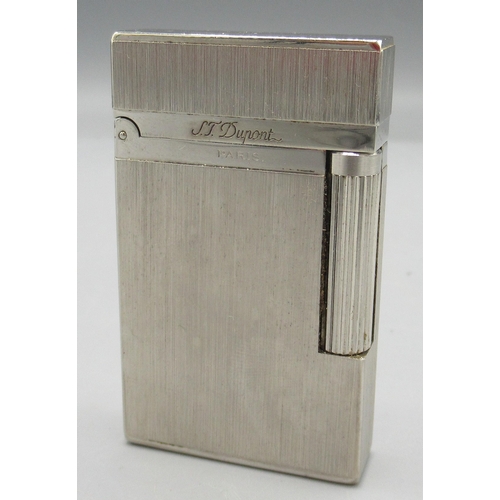 1161 - S.T. Dupont, Paris - chrome plated butane cigarette lighter, vertically brushed body, base signed no... 