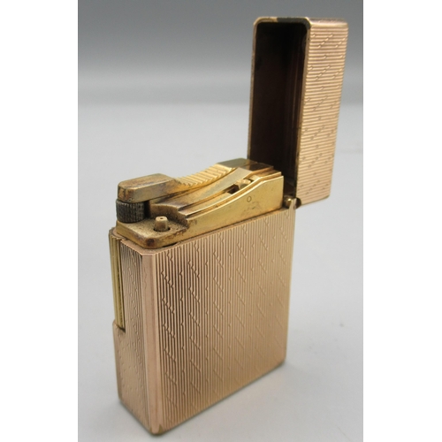 1163 - S.T. Dupont, Paris - gold plated butane cigarette lighter, vertically engraved and patterned body, b... 