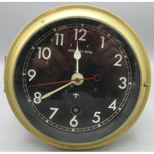 1121 - British Royal Navy brass bulkhead clock, black dial with white Arabic numerals, white hands and red ... 