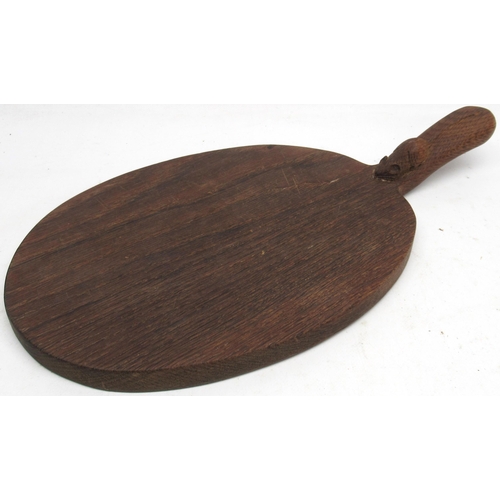 1347 - Robert Mouseman Thompson of Kilburn - an oak oval cheese board, curved handle carved with signature ... 