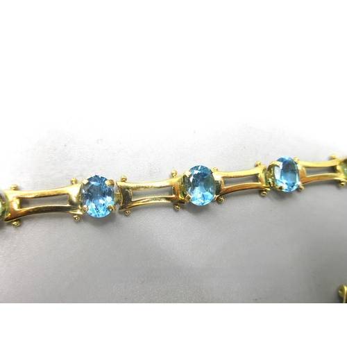 1002 - 18ct yellow gold bracelet set with oval cut blue stones, stamped 750, L19.5cm, and a similar unmarke... 