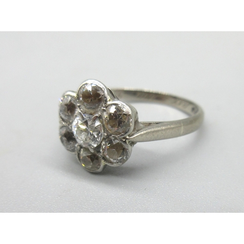 1003 - 18ct white gold diamond cluster ring, the seven old cut diamonds set in flower shaped cluster, in ru... 