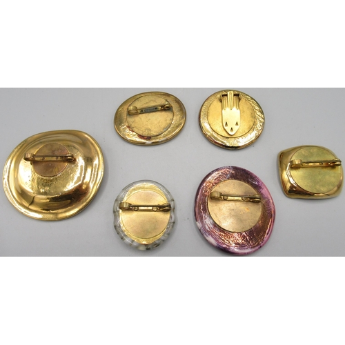 1145 - Orplid (Bimini) Glassworks - five glass brooches and a dress clip, c1940s/1950s, centrally moulded w... 