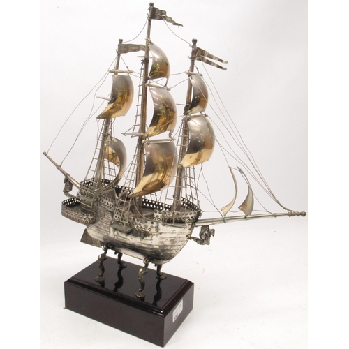 1039 - 20th century white metal model of a three masted gunship under full sail, on cabriole supports and r... 