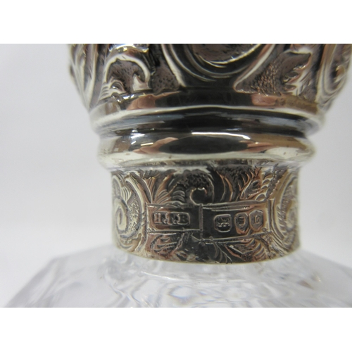 1136 - Three Victorian cut glass dressing table containers, the hallmarked Sterling silver lids with repous... 