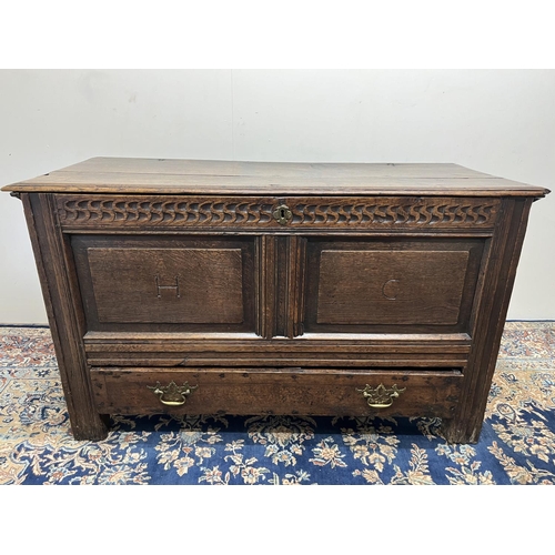 1323 - 18th century oak mule chest, with hinged moulded top and chip carved frieze, the two panel front car... 