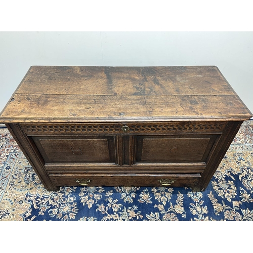 1323 - 18th century oak mule chest, with hinged moulded top and chip carved frieze, the two panel front car... 