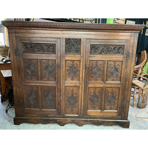 1304 - George 111 and later oak livery cupboard, dentil cornice above a pair of lozenge and scroll carved p... 