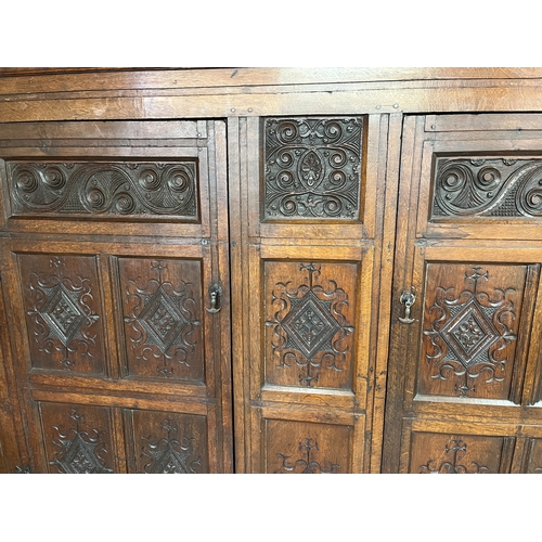 1304 - George 111 and later oak livery cupboard, dentil cornice above a pair of lozenge and scroll carved p... 