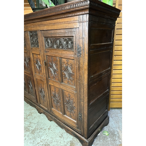 1304 - George 111 and later oak livery cupboard, dentil cornice above a pair of lozenge and scroll carved p... 