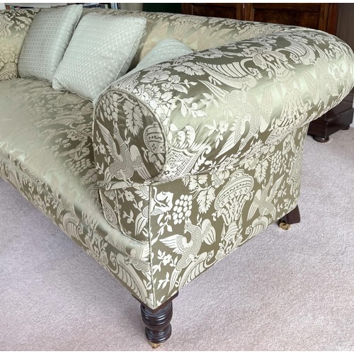 1308 - Victorian style Chesterfield sofa, with outsplayed arms on turned supports with brass sockets and ba... 