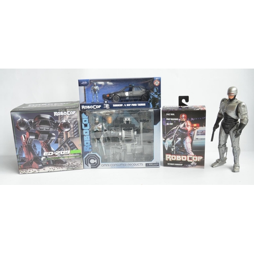 76 - Collection of Robo Cop themed action figure and model sets to include a Neca ED-209 (box opened, wil... 