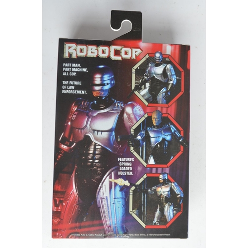 76 - Collection of Robo Cop themed action figure and model sets to include a Neca ED-209 (box opened, wil... 