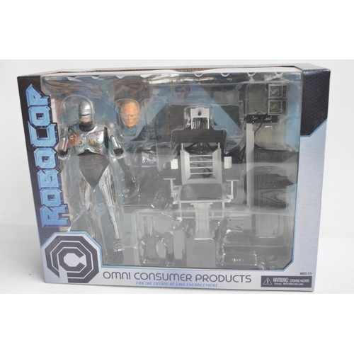 76 - Collection of Robo Cop themed action figure and model sets to include a Neca ED-209 (box opened, wil... 