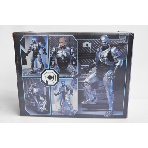 76 - Collection of Robo Cop themed action figure and model sets to include a Neca ED-209 (box opened, wil... 