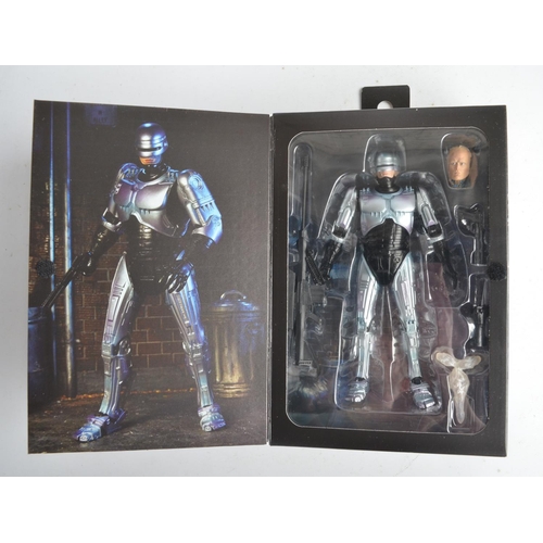 76 - Collection of Robo Cop themed action figure and model sets to include a Neca ED-209 (box opened, wil... 