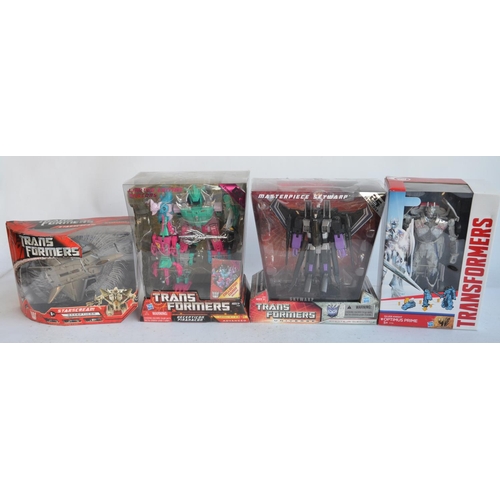 166 - Four Transformer models from Hasbro to include Silver Knight Optimus Prime (approx 8.5