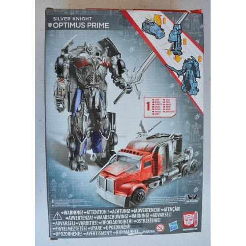 166 - Four Transformer models from Hasbro to include Silver Knight Optimus Prime (approx 8.5