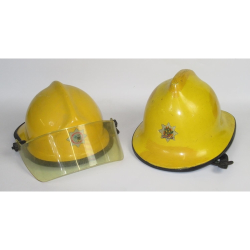 Five British vintage firefighter helmets of various styles and eras ...