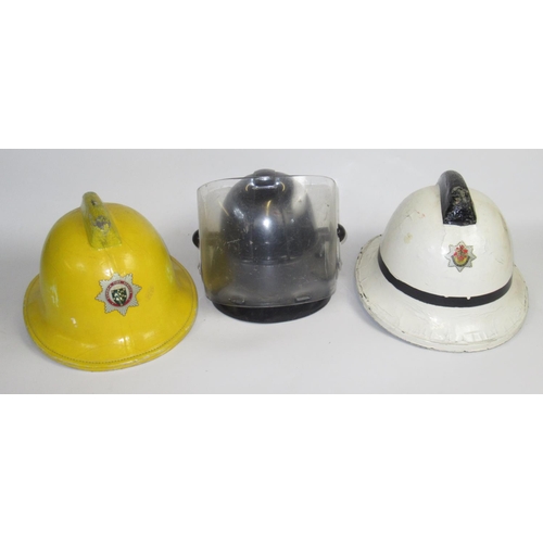 1291 - Five British vintage firefighter helmets of various styles and eras, including a c1993 Cumbrian Crom... 