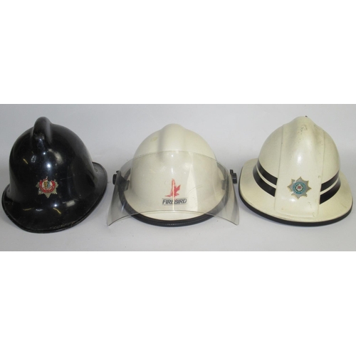 1293 - Three British vintage firefighter helmets of various styles and eras, including a c1950s Chester Fir... 