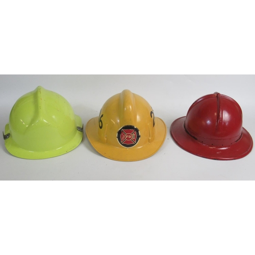 1295 - Three vintage American Fireman helmets, including an Orange County c1978 MSA pattern helmet, a c1991... 