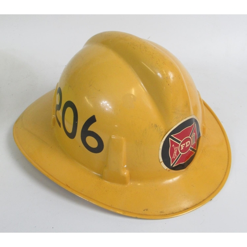 1295 - Three vintage American Fireman helmets, including an Orange County c1978 MSA pattern helmet, a c1991... 