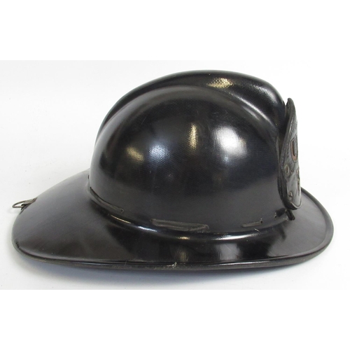 1298 - C1940s MSA 'Skullgard' helmet with U. S. Army Fire Department shield, complete with original interio... 