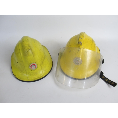 1305 - Five Irish vintage firefighter helmets of various styles and eras, including a c1994 Cairns and Bro ... 