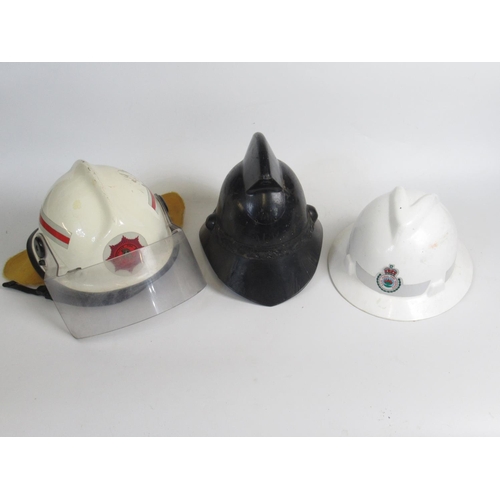 1306 - Three Australian vintage firefighter helmets of various styles and eras, including a c1998 MSA VGARD... 