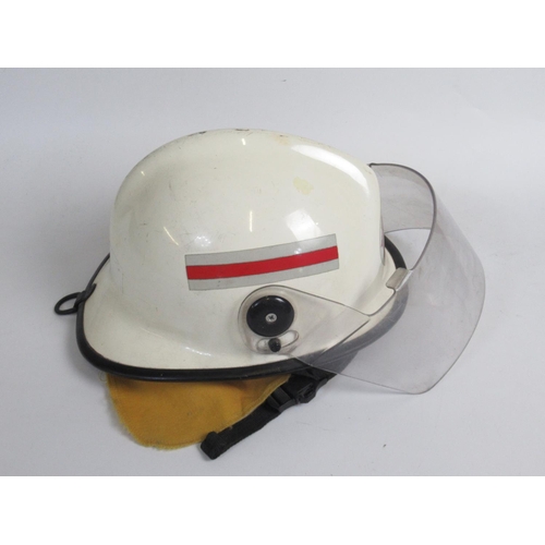 1306 - Three Australian vintage firefighter helmets of various styles and eras, including a c1998 MSA VGARD... 