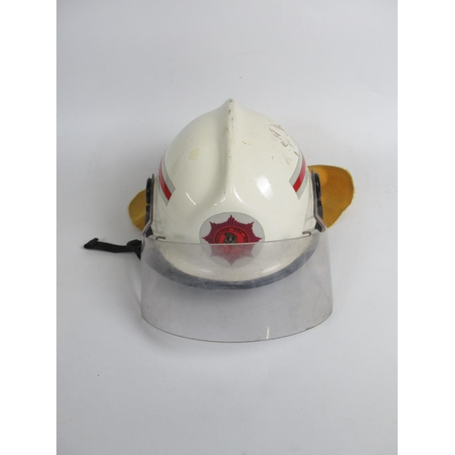 1306 - Three Australian vintage firefighter helmets of various styles and eras, including a c1998 MSA VGARD... 