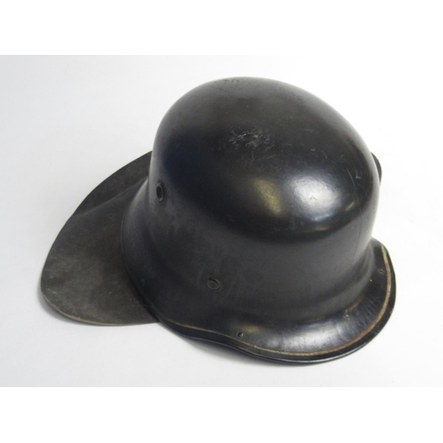 1316 - C1940s German black steel fireman helmet with neck guard and a C1970 steel fireman helmet with neck ... 