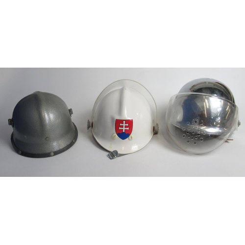 1318 - Three eastern European firefighter helmets, including a C1998 Slovakian plastic helmet, a C1980s Yug... 